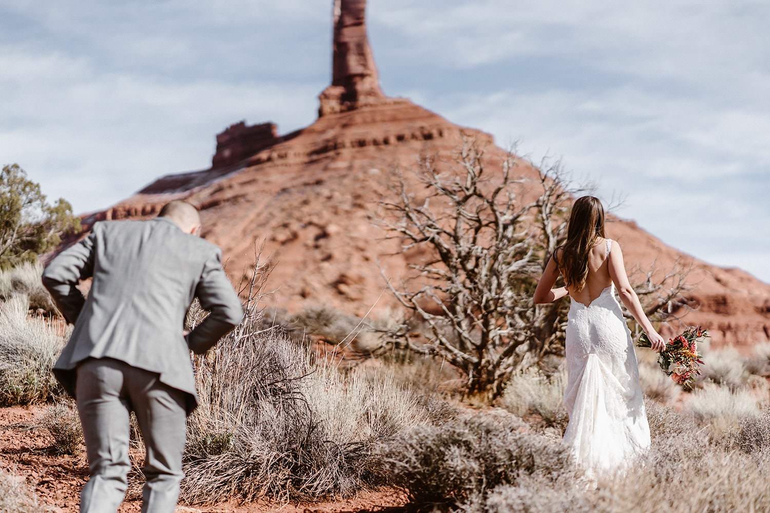 Bride and Groom Hiking During Moab Elopement