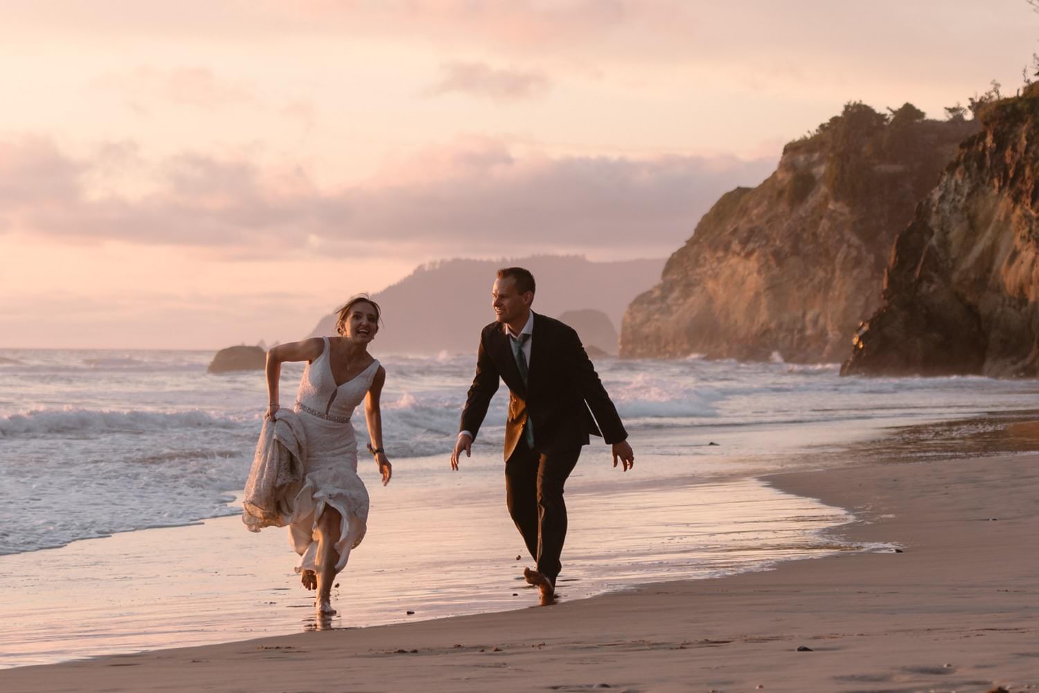Bride and Groom jumping in the air at Hug Point & Cannon Beach Elopement