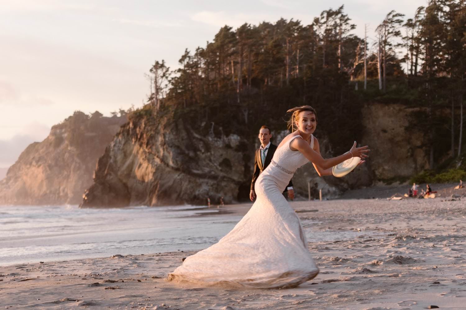 Bride and Groom playing frisbee at Hug Point & Cannon Beach Elopement