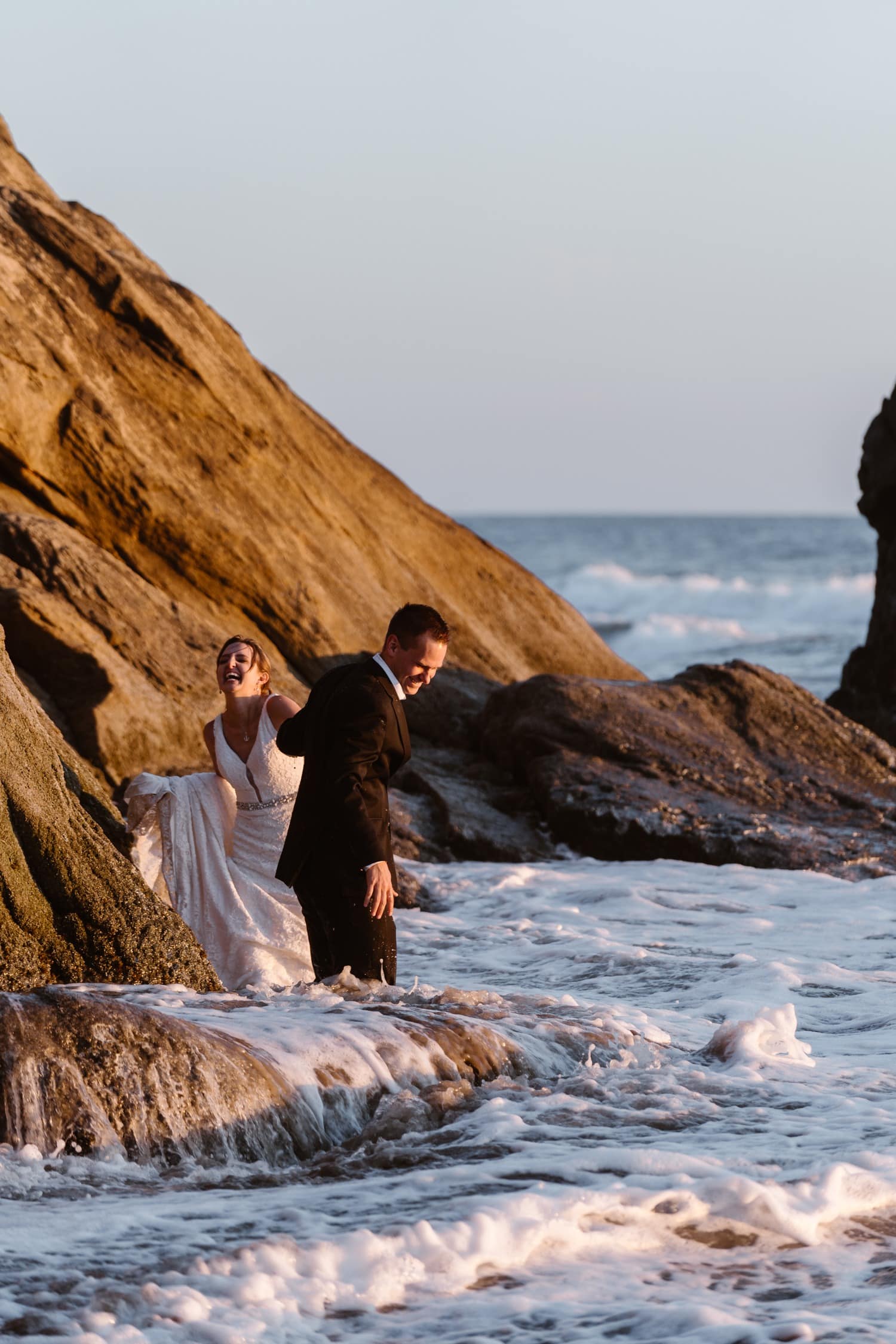 Bride and Groom in the ocean at Hug Point & Cannon Beach Elopement