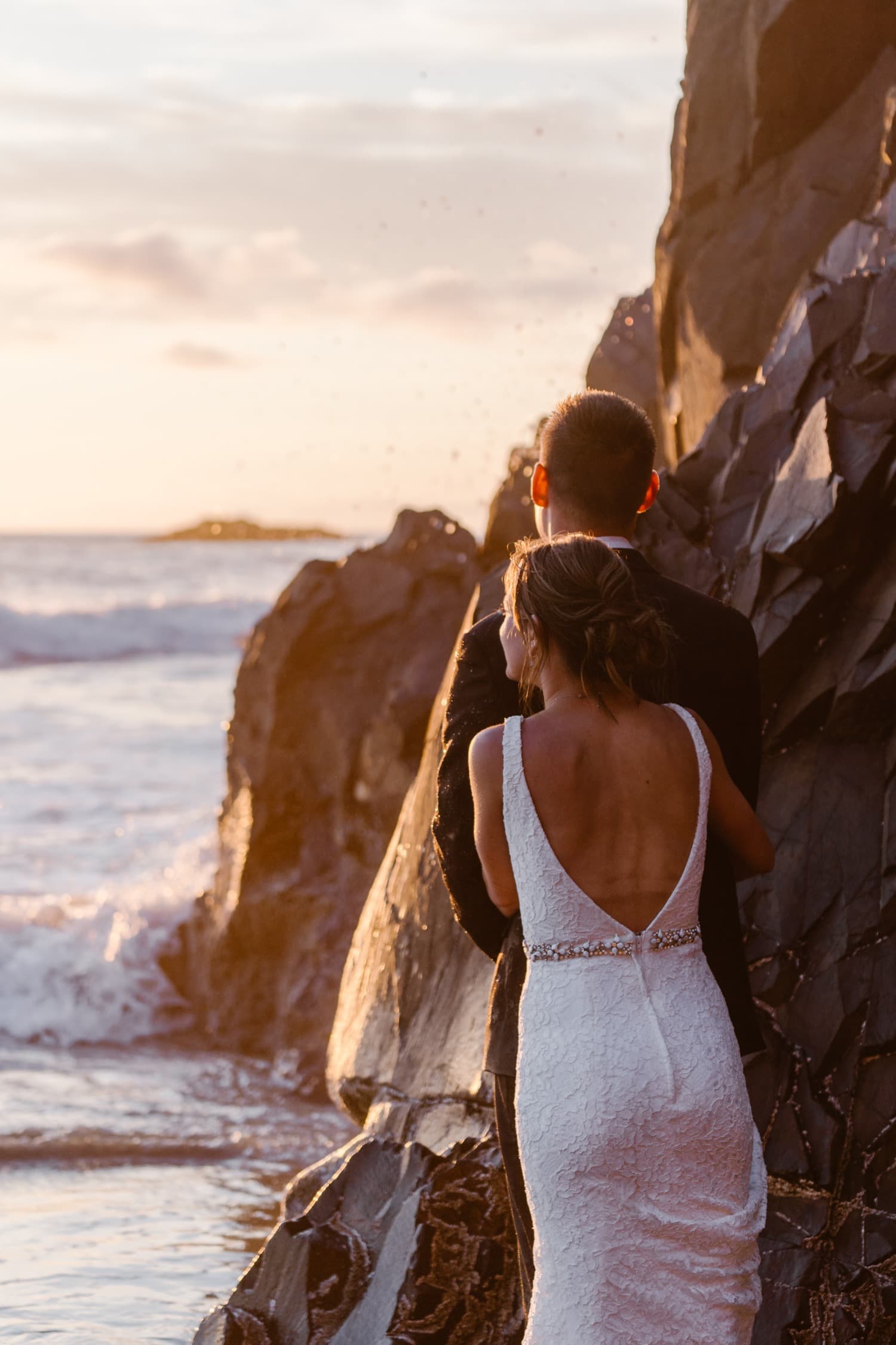 Bride and Groom in ocean at sunset at Hug Point & Cannon Beach Elopement