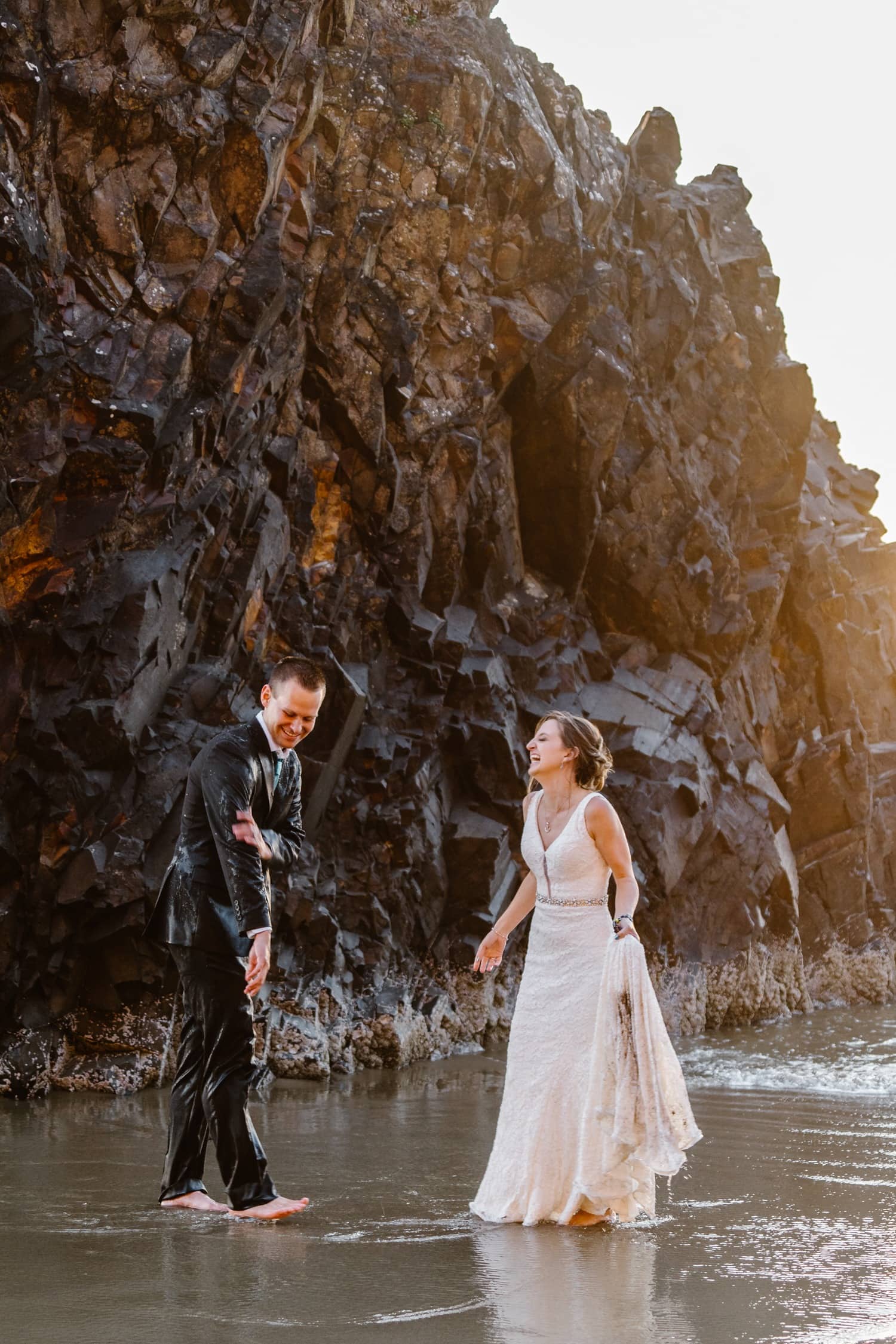Bride and Groom soaked in ocean water at Hug Point & Cannon Beach Elopement