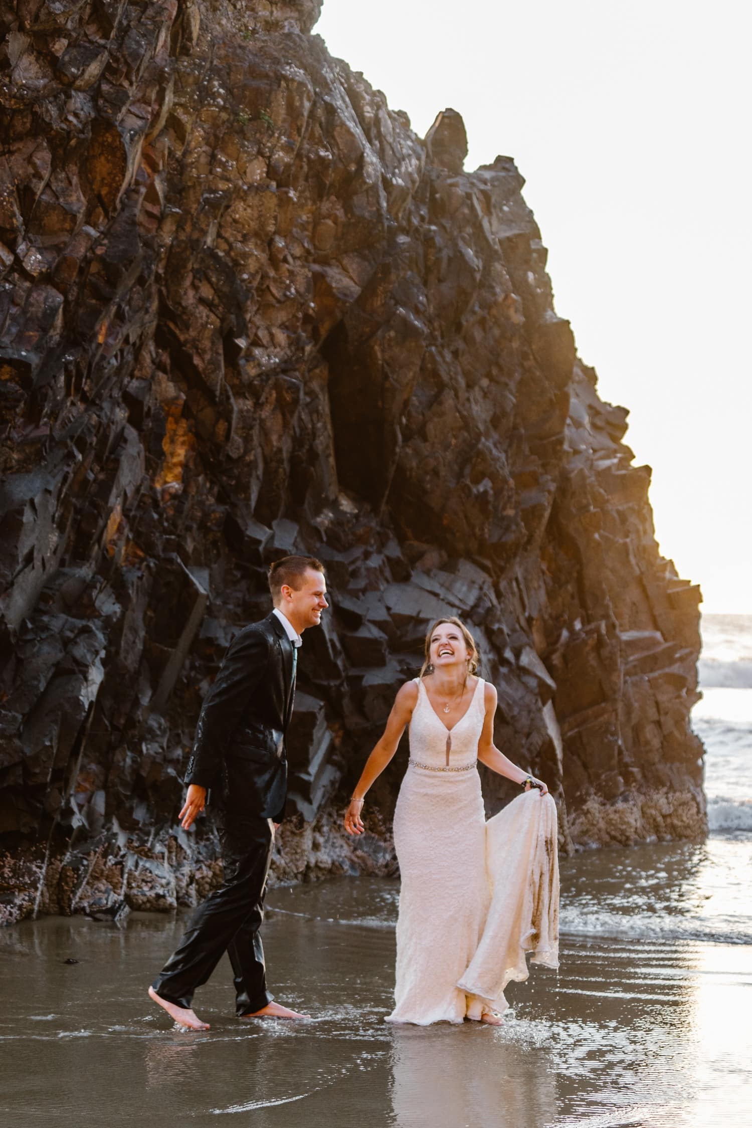 Bride and Groom soaked in ocean water at Hug Point & Cannon Beach Elopement