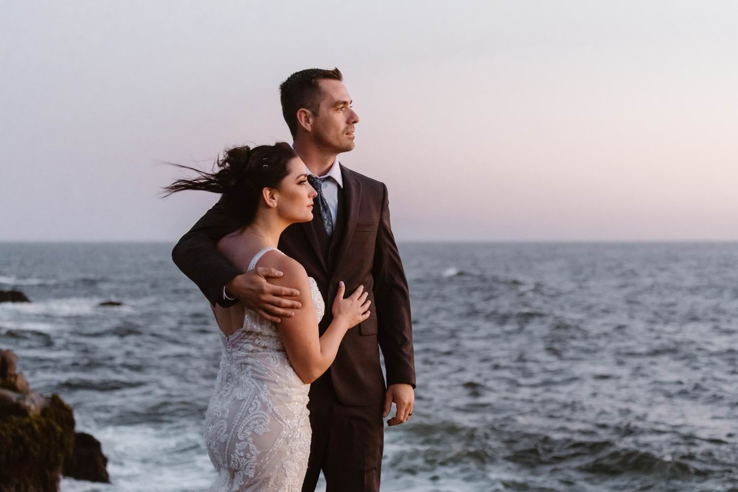 Bride and Groom posing near ocean at Big Sur Elopement
