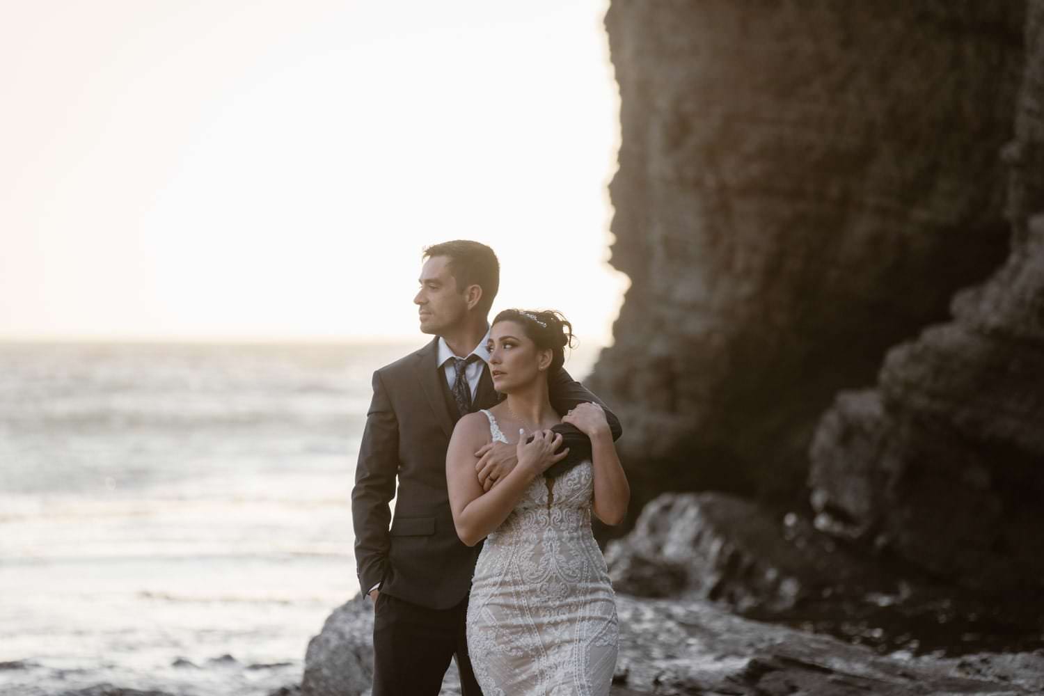 Bride and groom posing at sunset at Big Sur Elopement