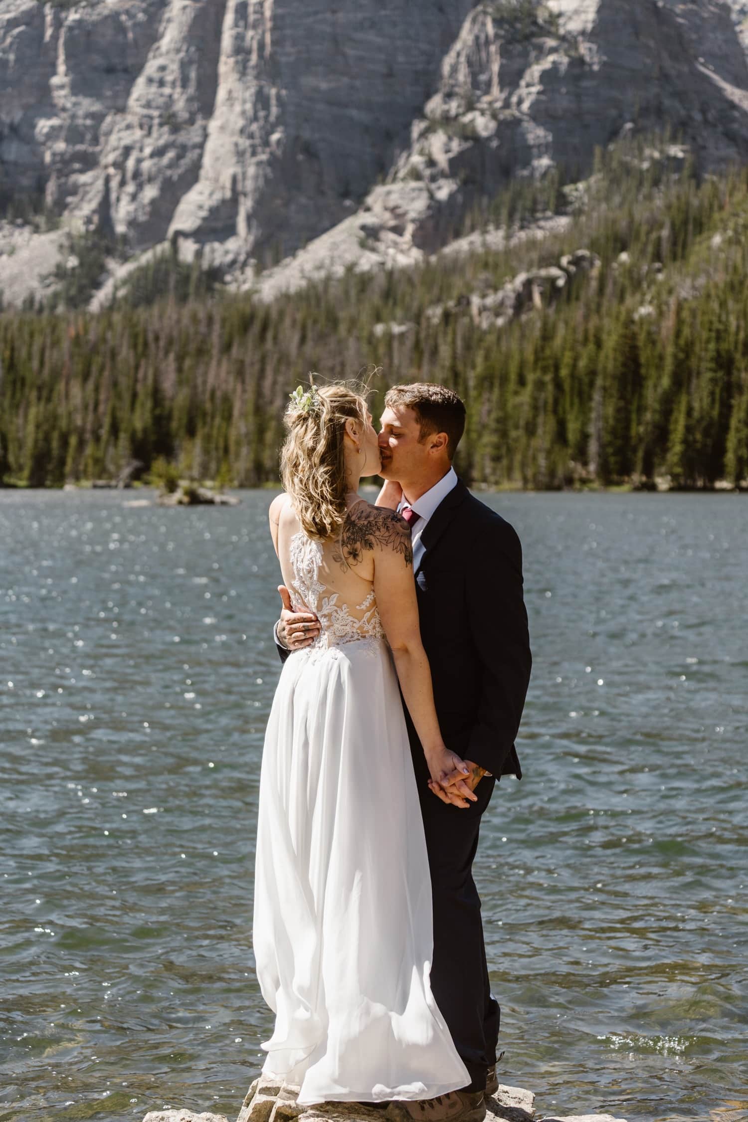 Bride and groom kissing at Loch Lake at Rocky Mountain National Park Hiking Elopement