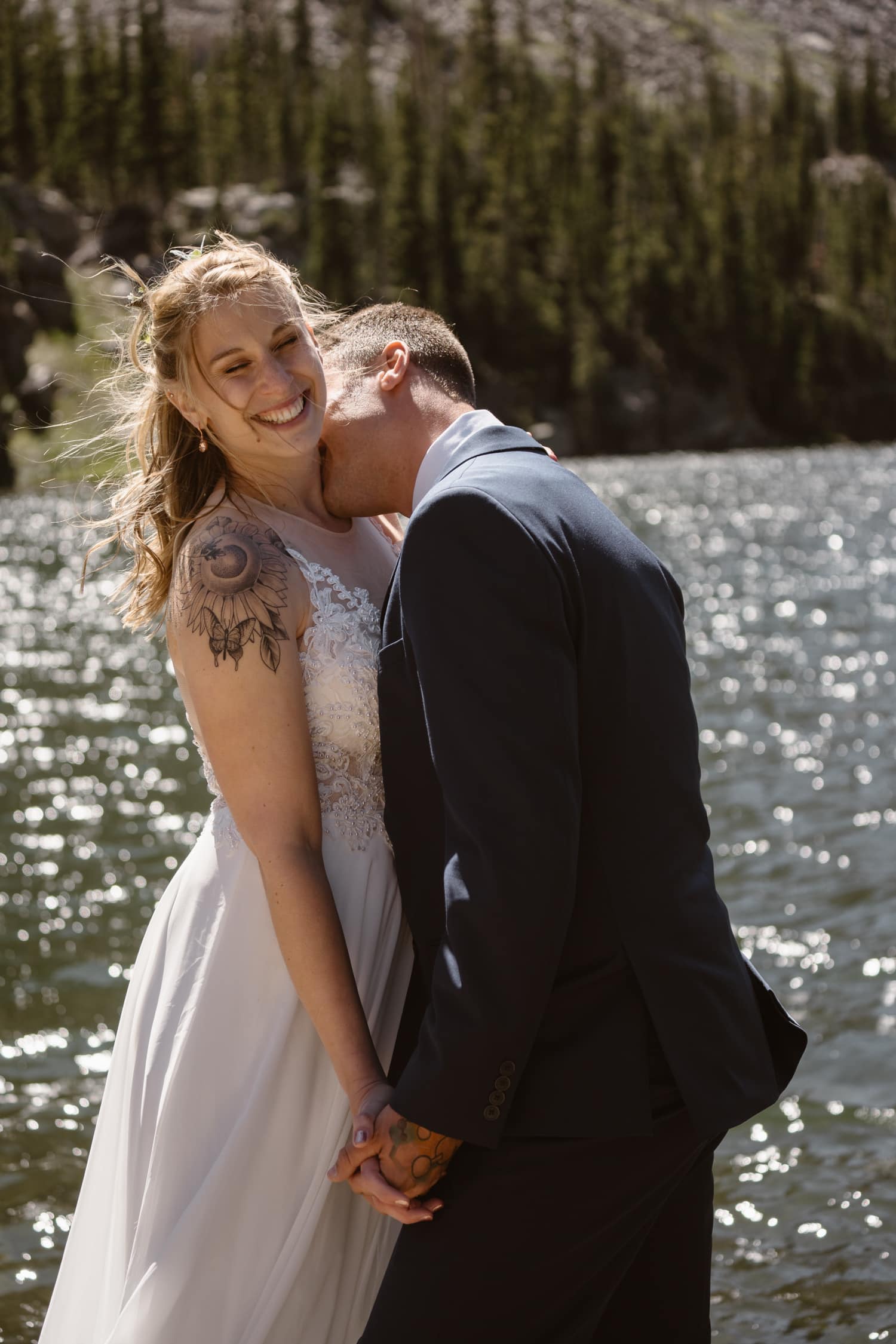Bride and groom kissing at Loch Lake at Rocky Mountain National Park Hiking Elopement