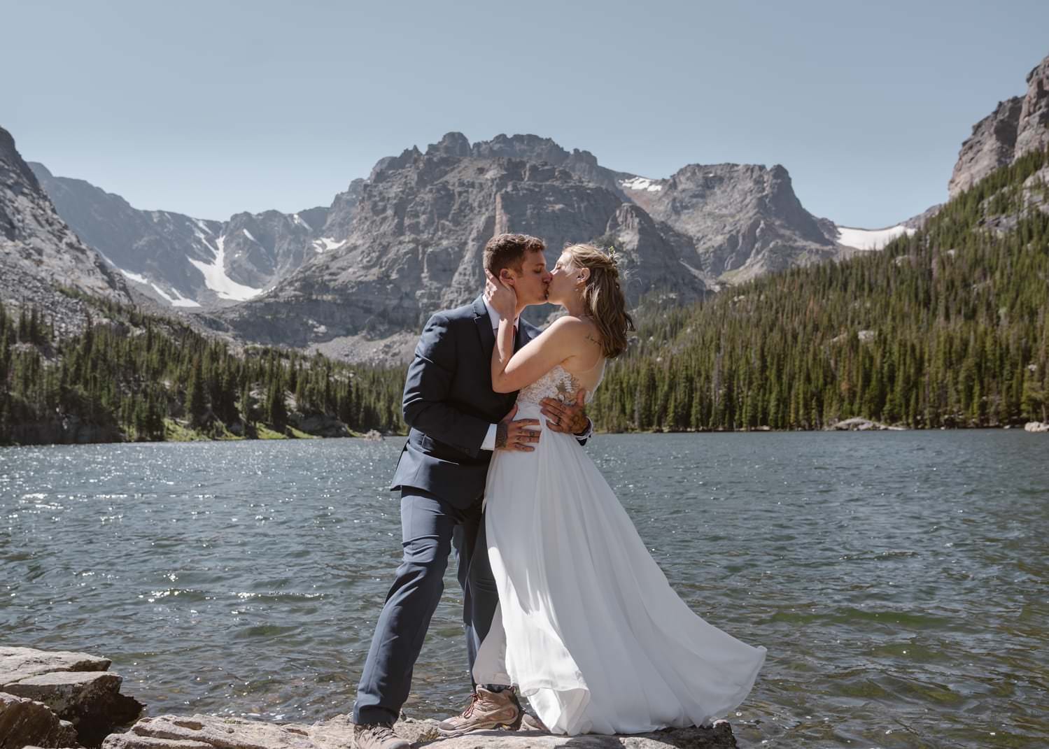 Bride and groom kissing at Loch Lake at Rocky Mountain National Park Hiking Elopement