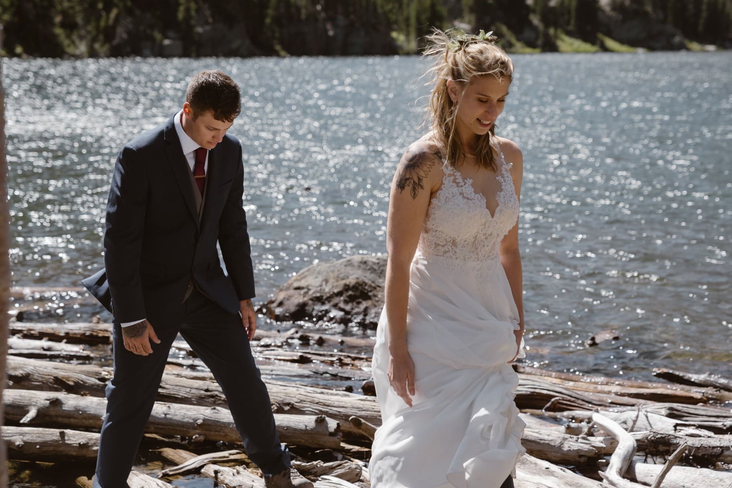 Bride and groom hiking at Loch Lake at Rocky Mountain National Park Hiking Elopement