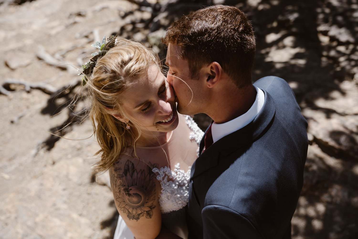 Bride and groom kissing at Loch Lake at Rocky Mountain National Park Hiking Elopement