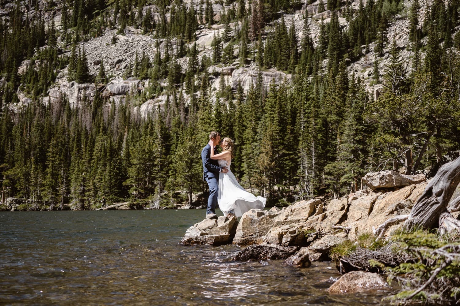 Bride and groom kissing at Loch Lake at Rocky Mountain National Park Hiking Elopement