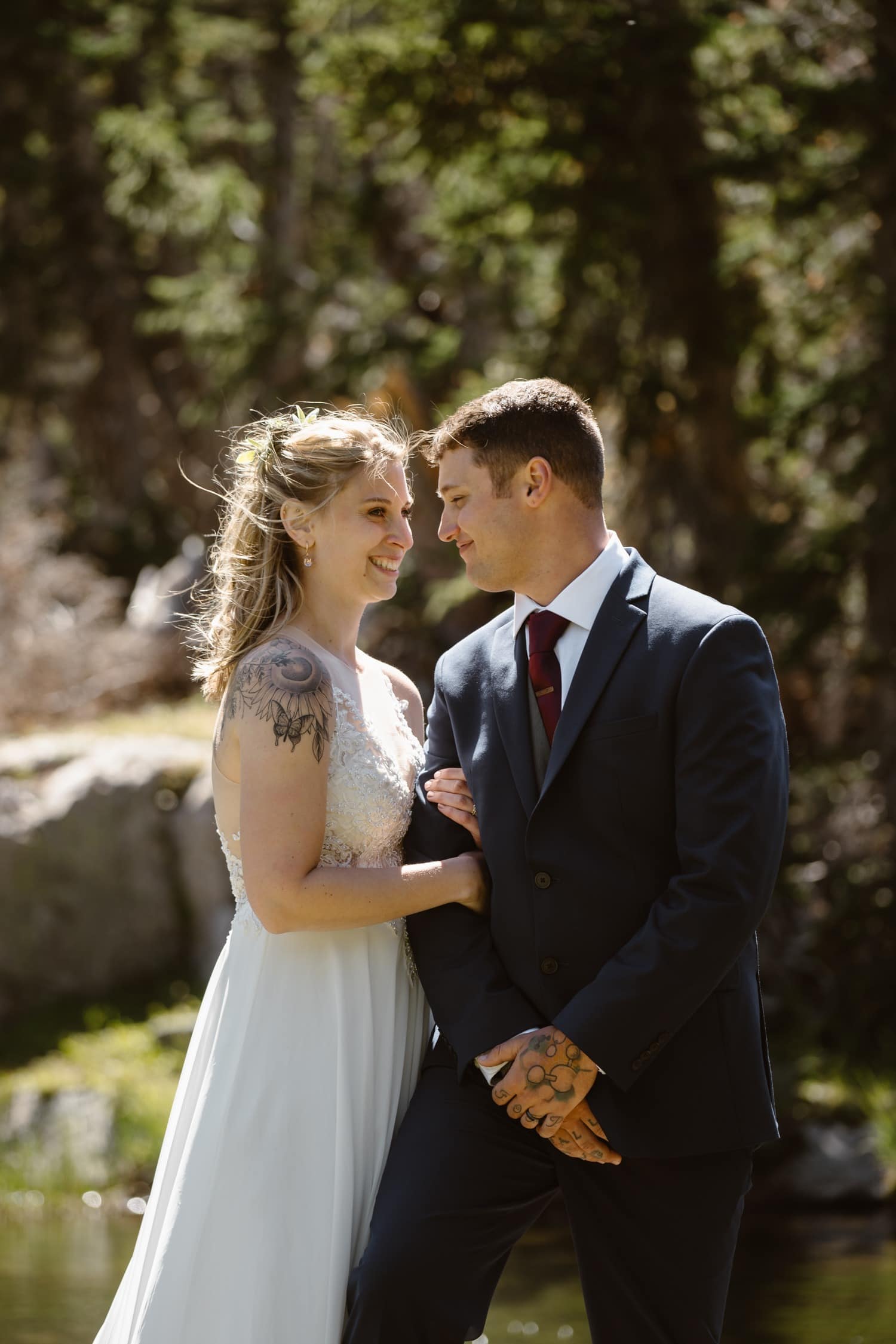 Bride and groom laughing at Loch Lake at Rocky Mountain National Park  Hiking Elopement