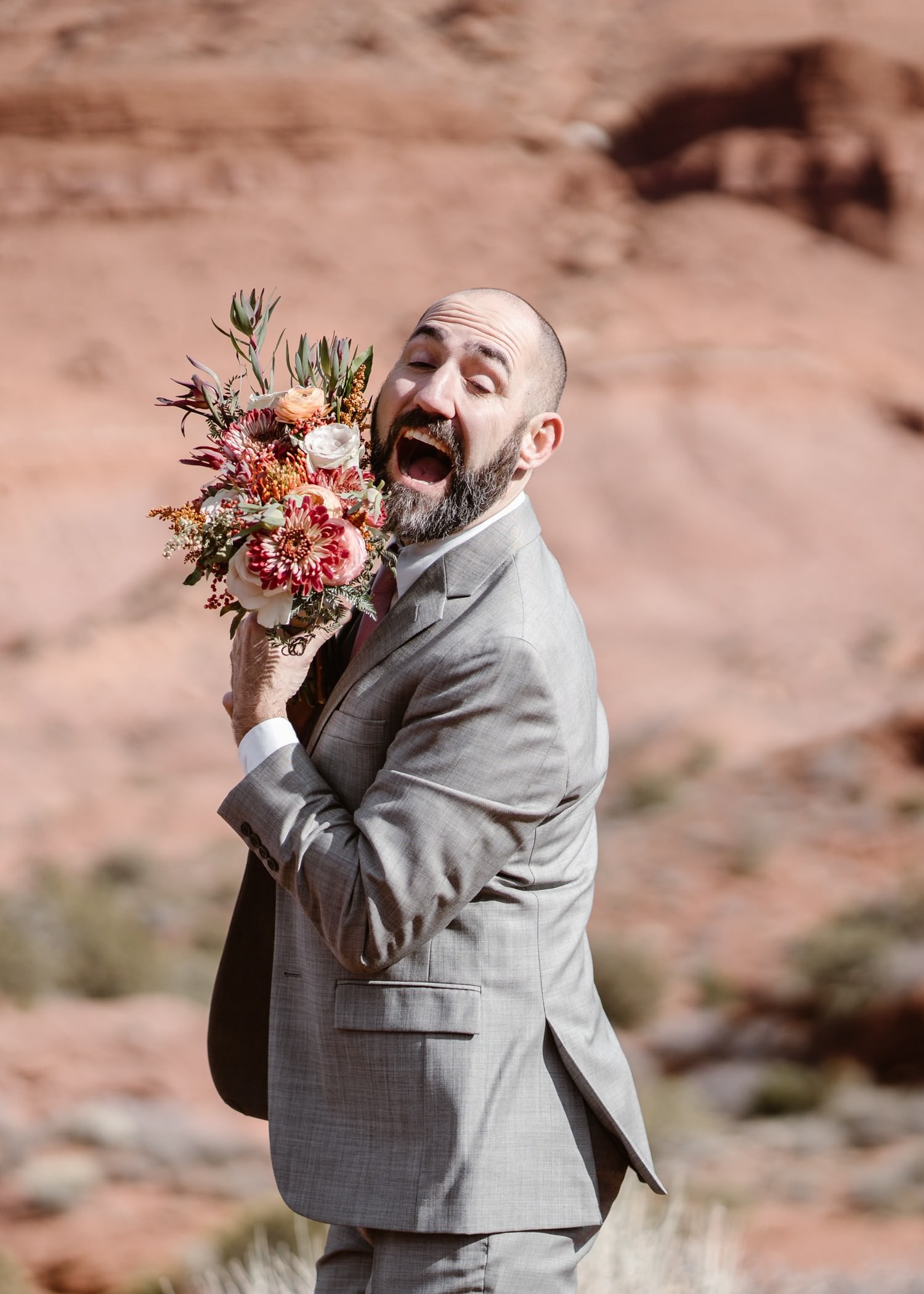 Groom With Flowers at Moab Elopement
