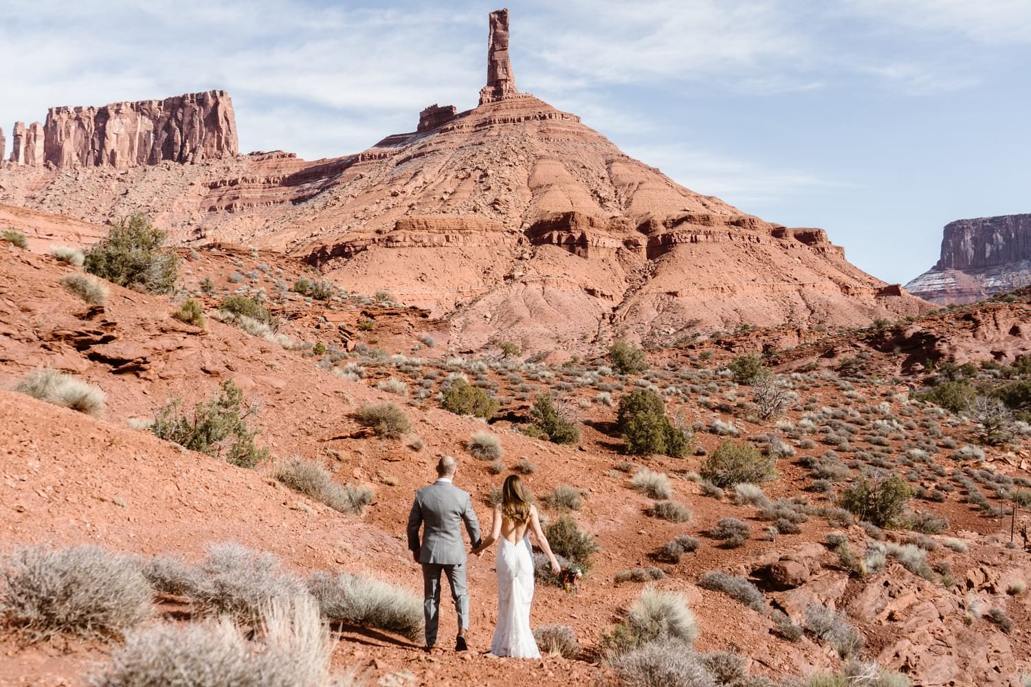 Bride and Groom Hiking During Moab Elopement