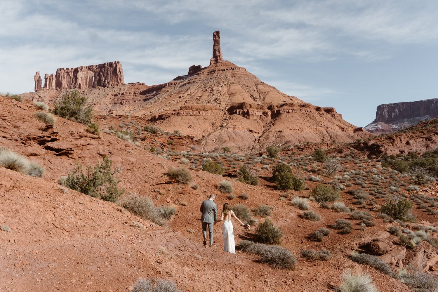 Bride and Groom Hiking During Moab Elopement