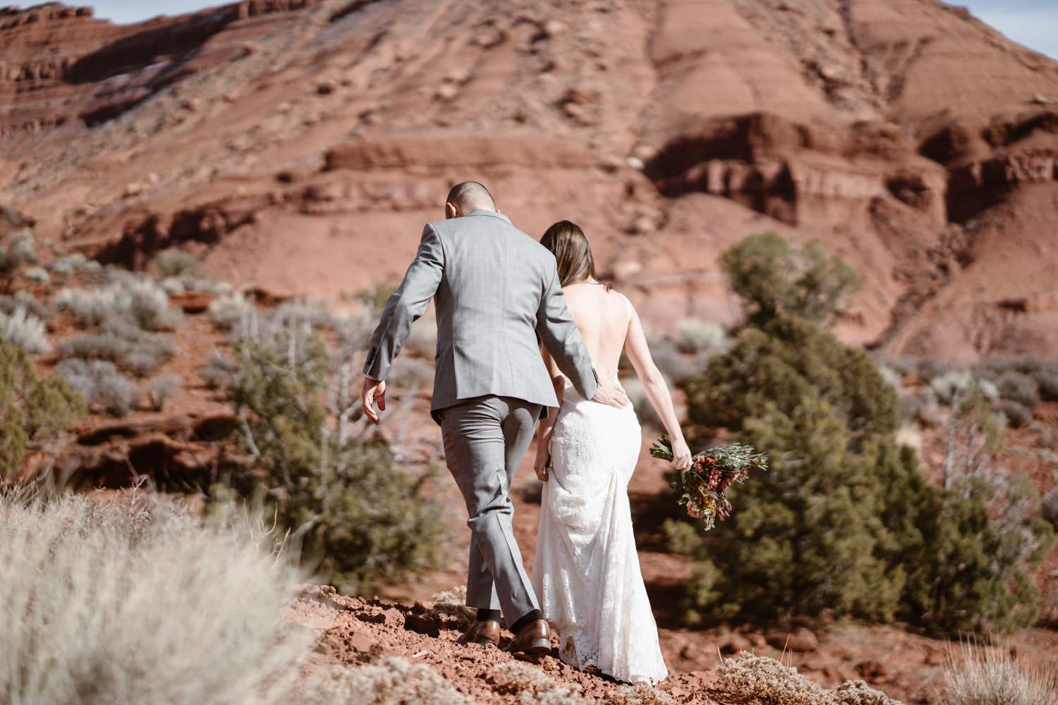 Bride and Groom Hiking During Moab Elopement