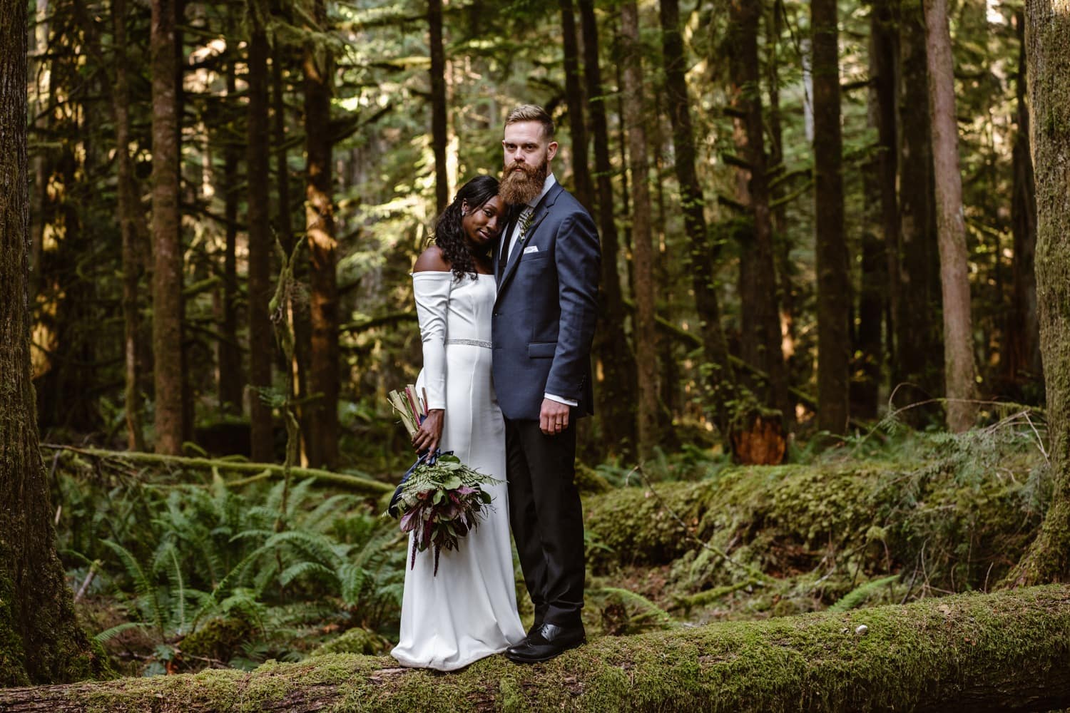 Bride and Groom hiking in forest at  Olympic National Park Elopement