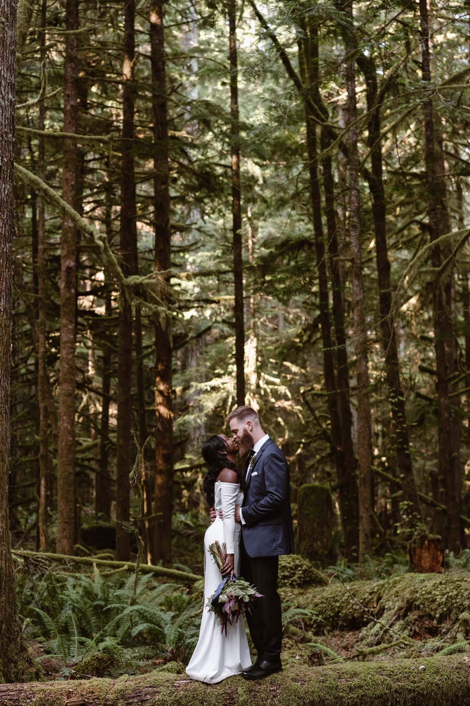  Bride and Groom kissing in forest at  Olympic National Park Elopement
