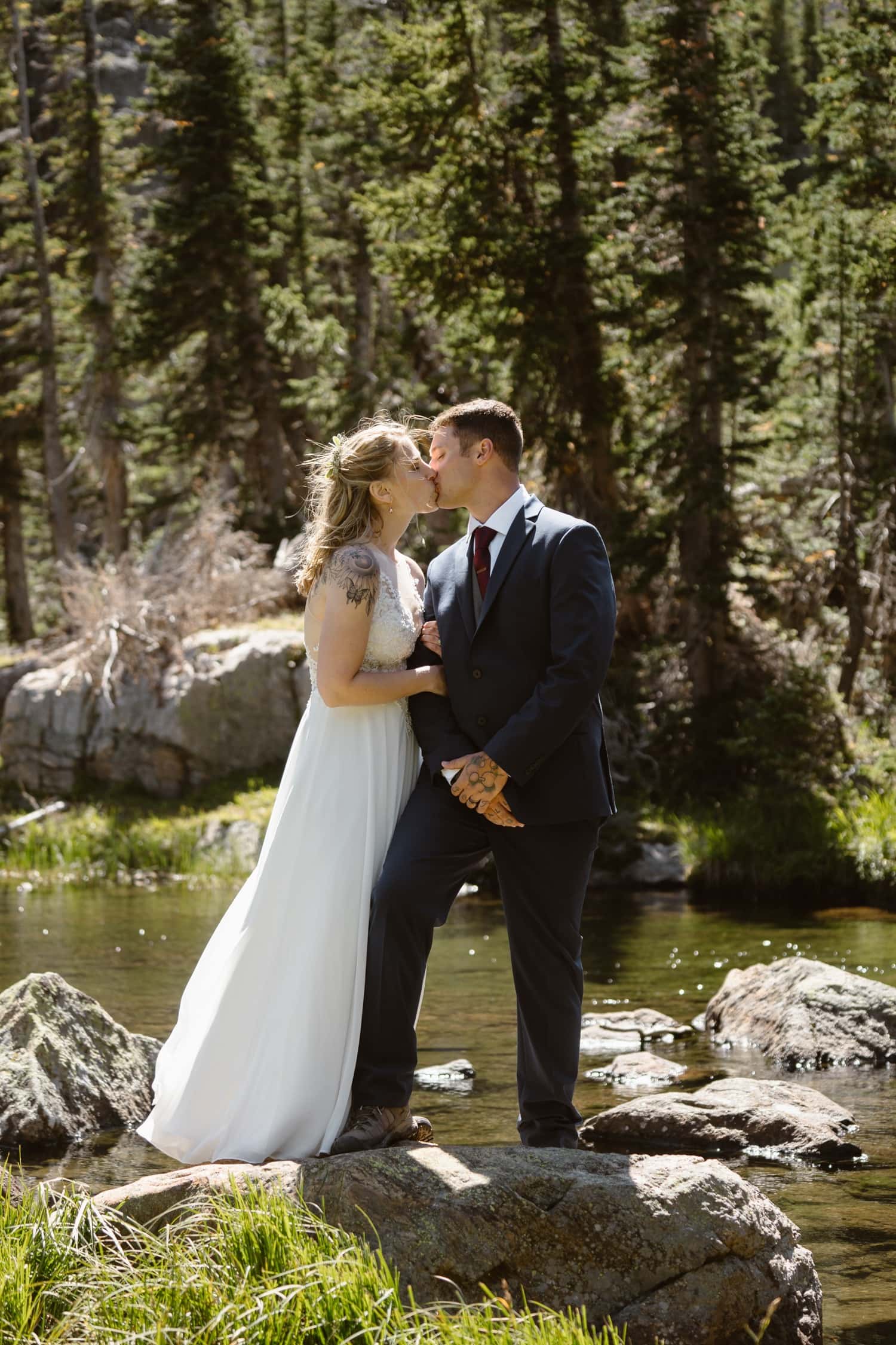 Bride and groom laughing at Loch Lake at Rocky Mountain National Park Hiking Elopement