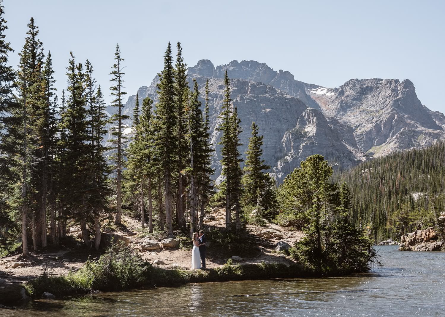 Bride and groom laughing at Loch Lake at Rocky Mountain National Park  Hiking Elopement