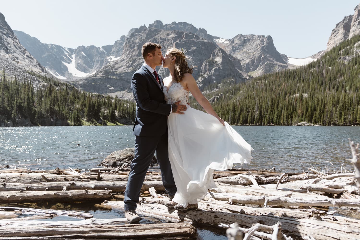 Bride and groom hiking at Loch Lake at Rocky Mountain National Park Hiking Elopement
