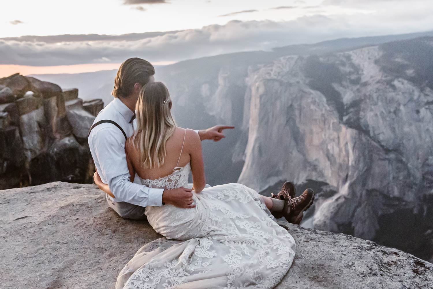 Bride and Groom Sitting at Taft Point Yosemite Elopement