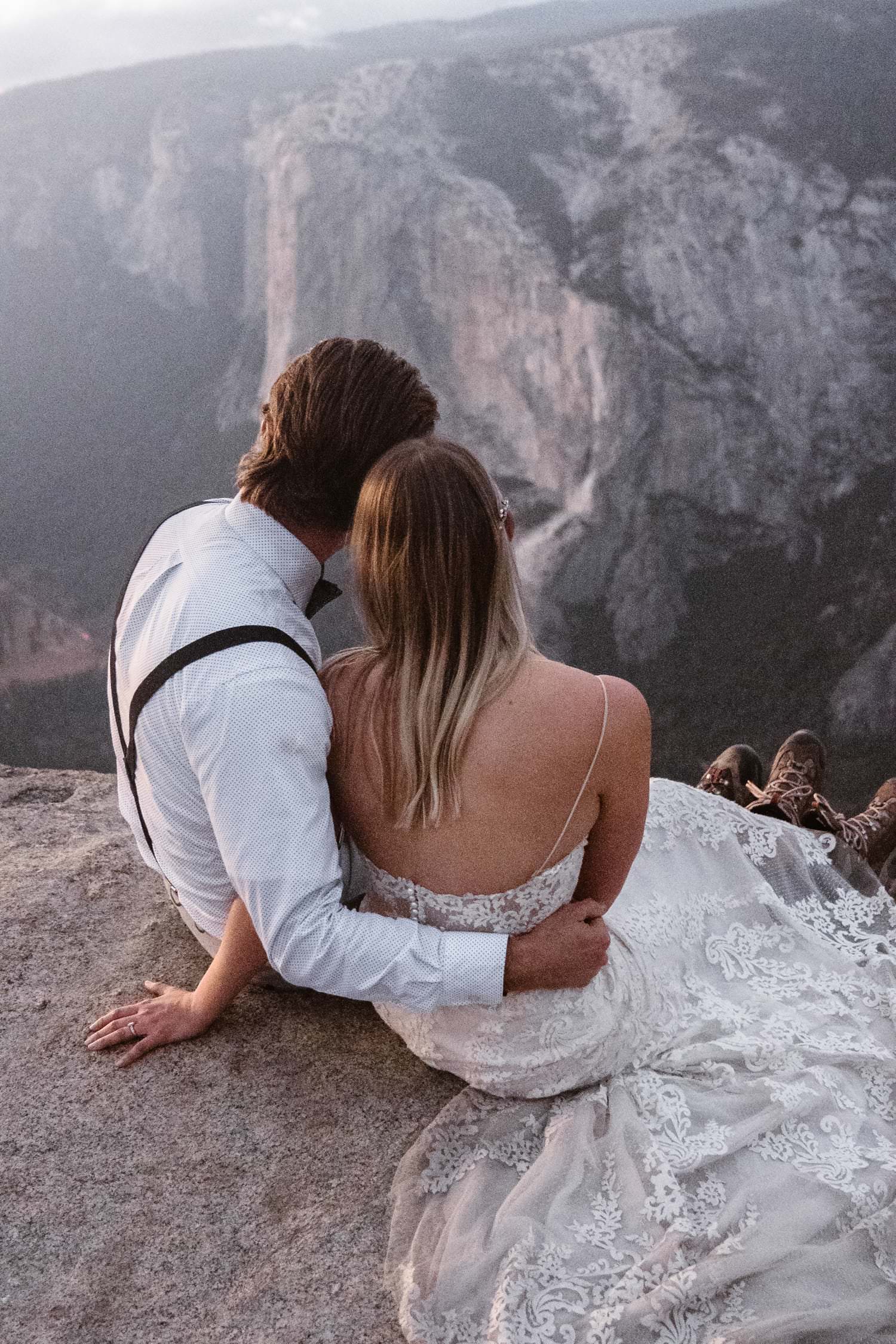 Bride and Groom Sitting at Taft Point Yosemite Elopement