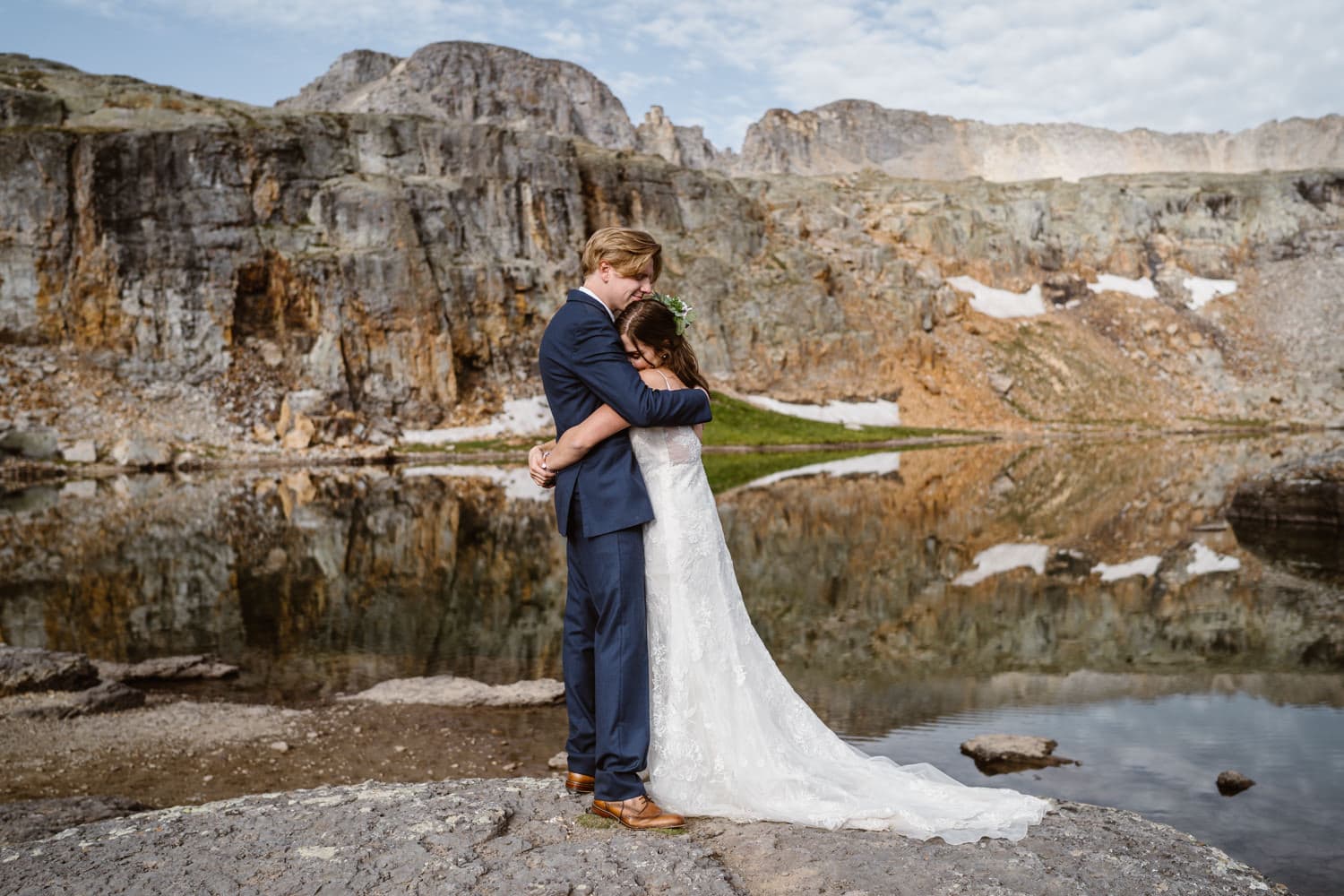 Couple sharing hug near alpine lake for their Colorado elopement.