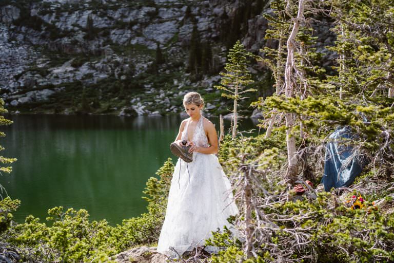 Bride putting her shoe on at her hiking elopement.