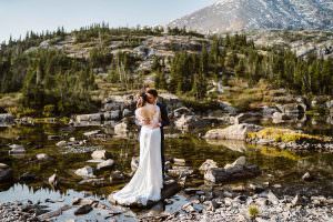 Couple standing near an alpine lake for their Breckenridge elopement.
