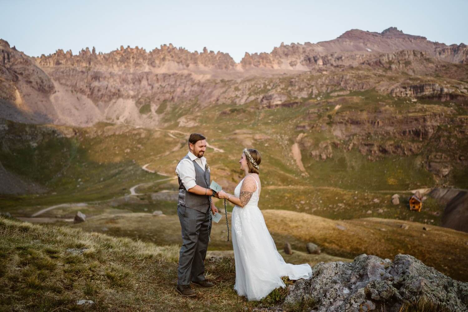 Couple sharing vows in the mountains at their off roading elopement.