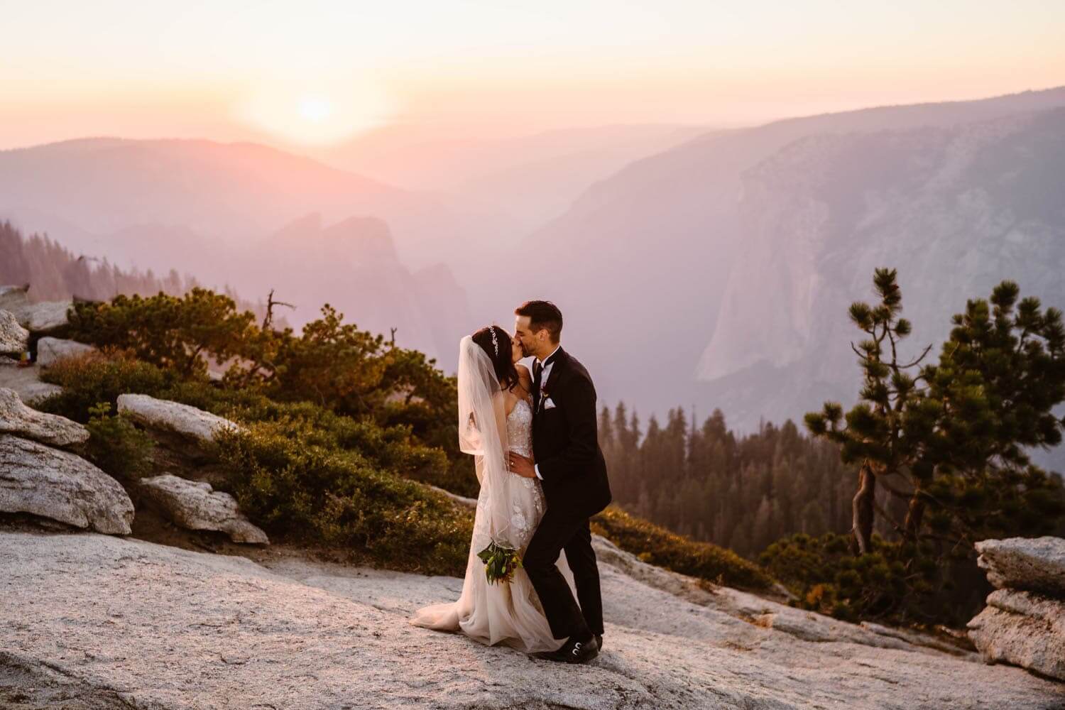 Couple kissing at Glacier Point for their Yosemite elopement.