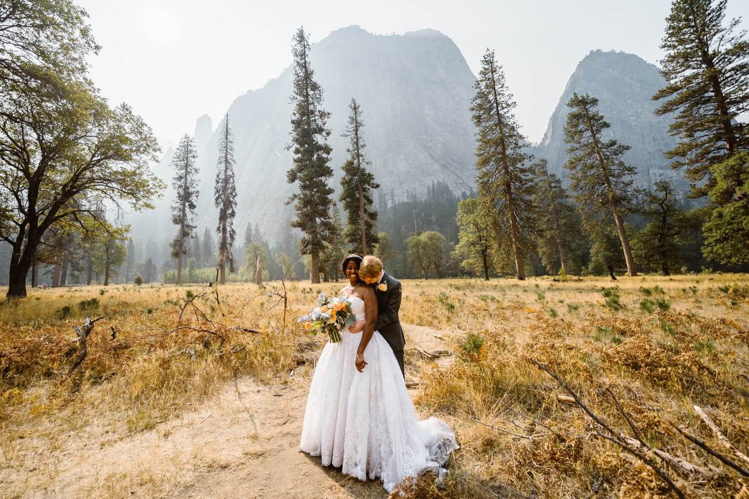 Couple together in El Capitan meadow in Yosemite for their elopement.