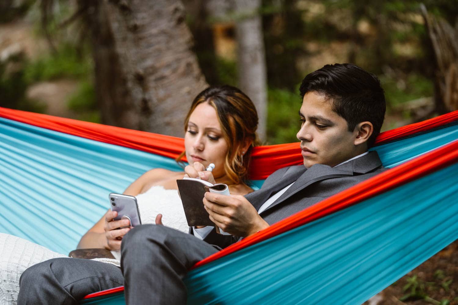 Couple in a hammock for their elopement activity.