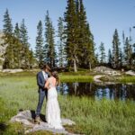 Couple standing near wildflowers in Colorado for their elopement.