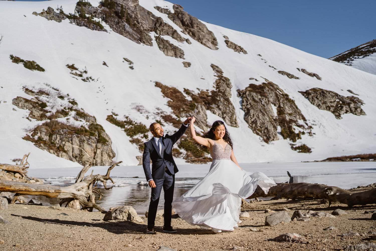 Bride dancing with groom at St. Marys Glacier in Colorado.