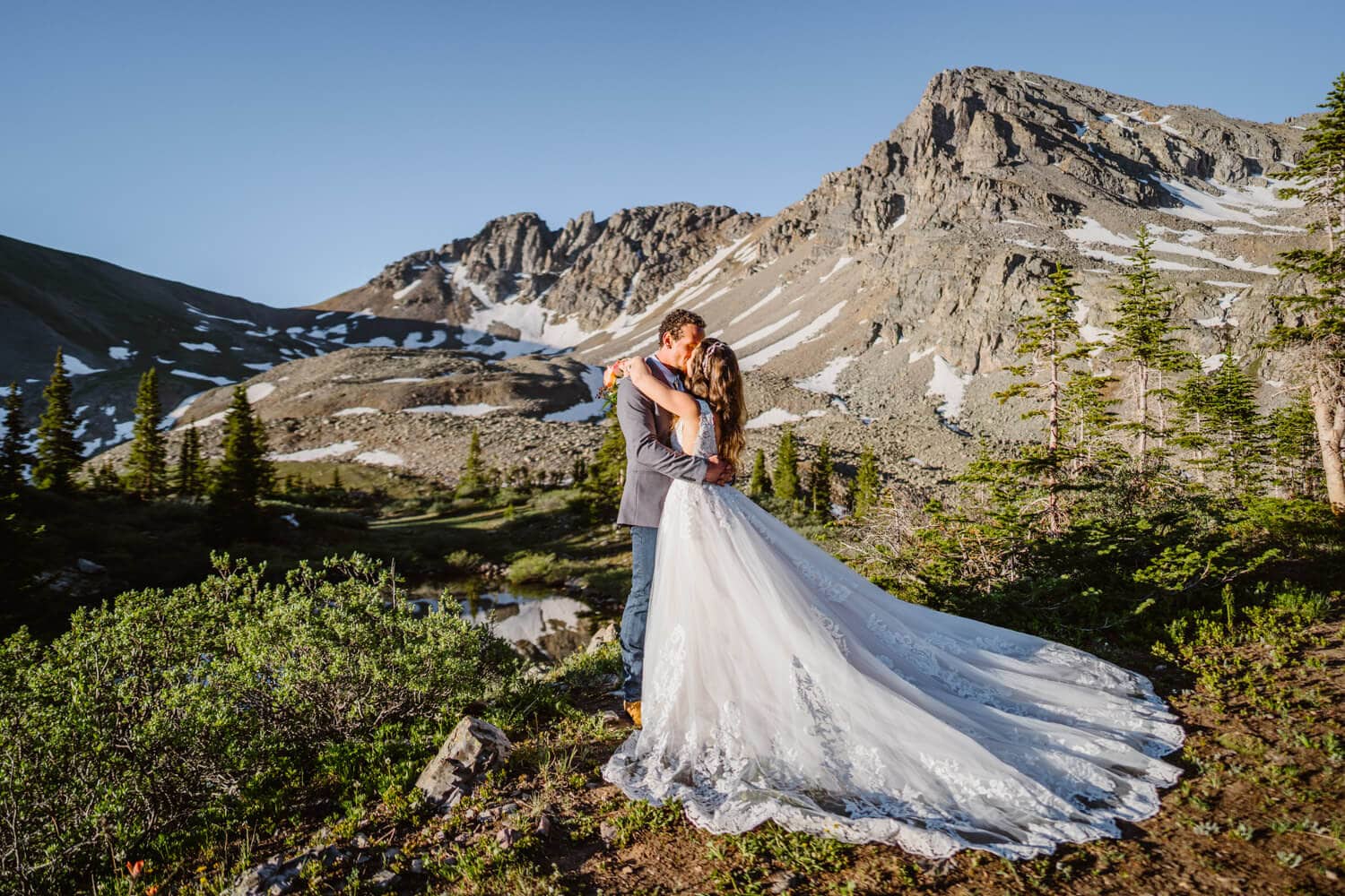 Sunrise elopement in Aspen, Colorado. Couple kissing in their wedding attire.