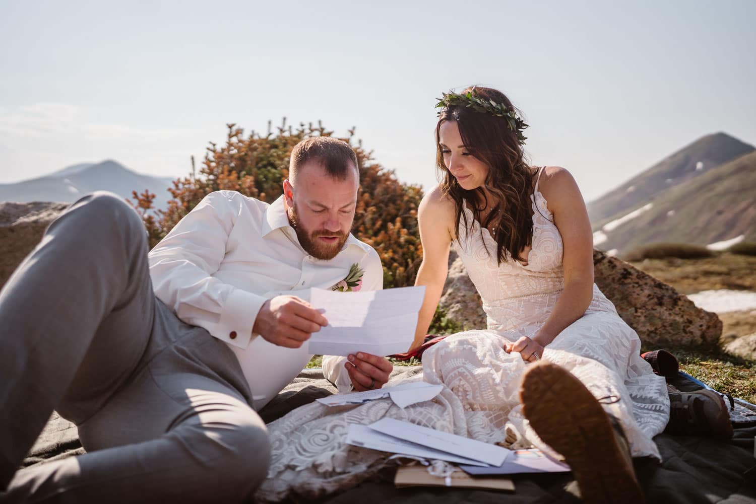 Bride and Groom Reading Letters at Sunrise Elopement in Colorado