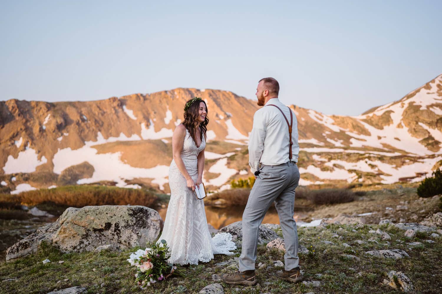 A bride and groom laughing during their elopement in Colorado.
