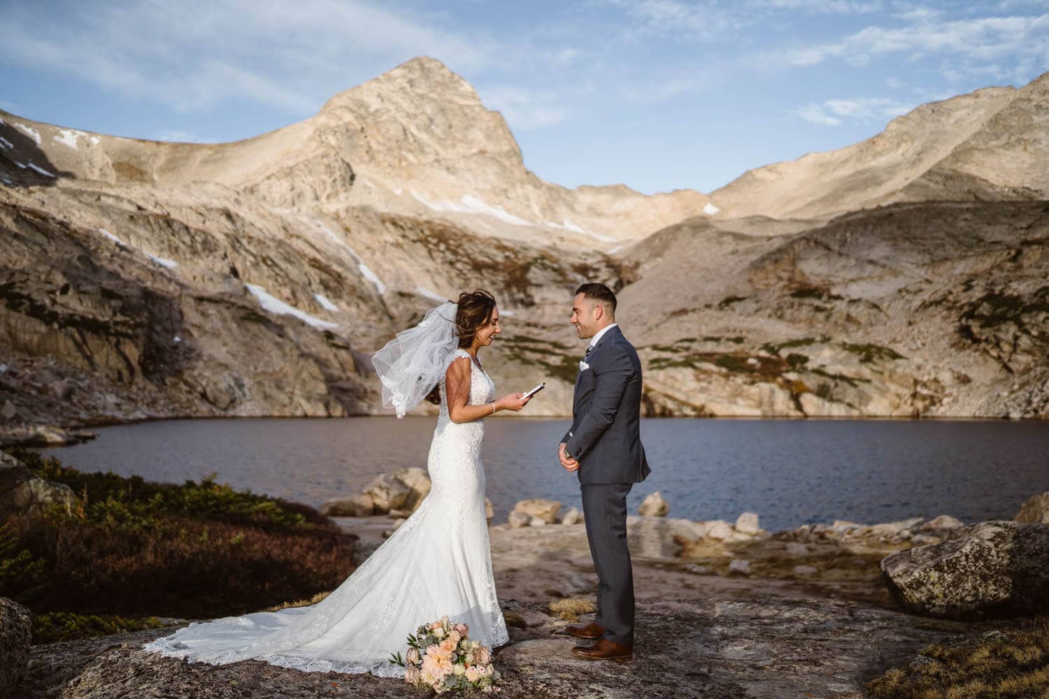 A bride and groom sharing their vows at sunrise in the mountains.