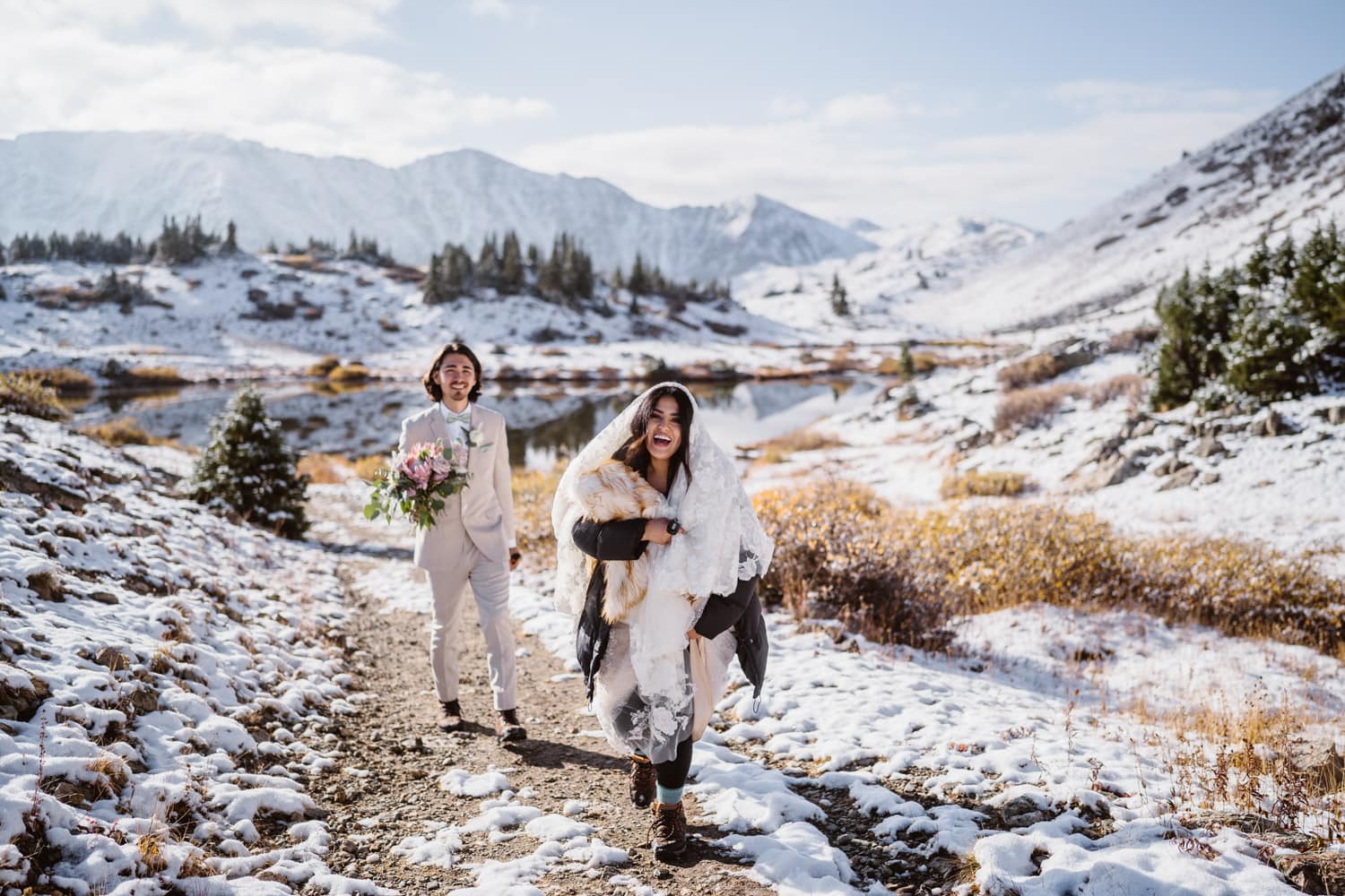 Hiking elopement at Guanella Pass Bride and groom hiking up in the snow at their Colorado elopement
