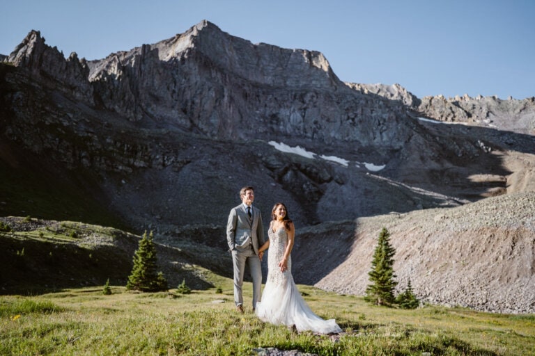 Couple standing beneath peaks for their Colorado elopement