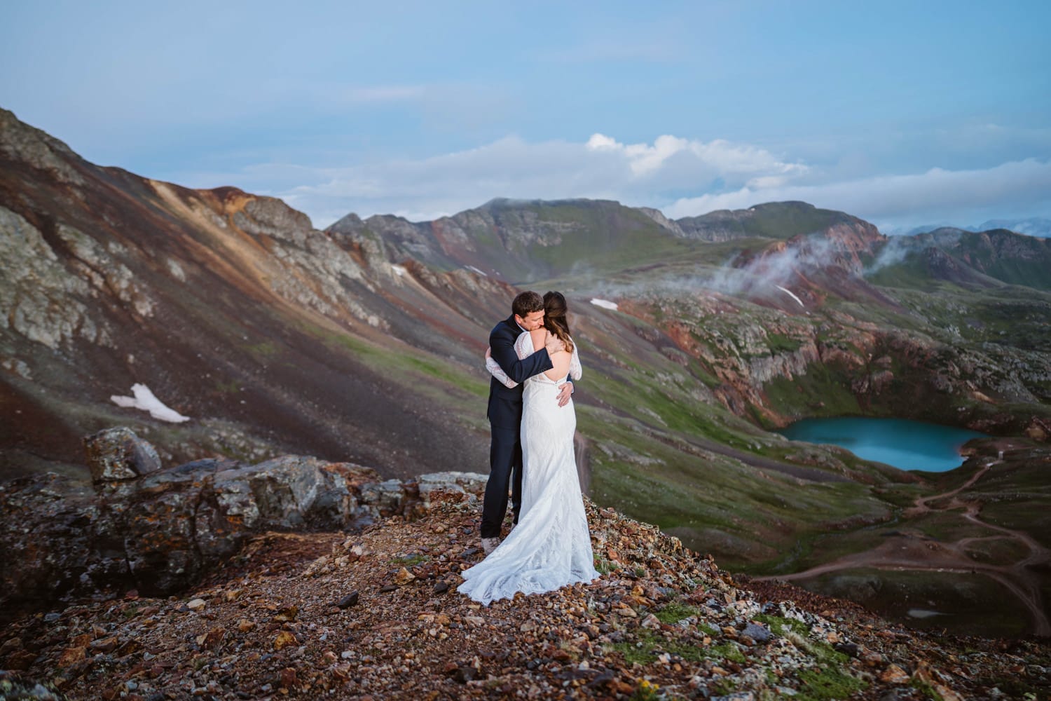 Couple sharing hug at sunrise in the mountains for their Colorado elopement.