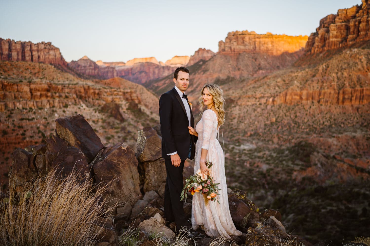 Bride and groom at sunset in the desert elopement