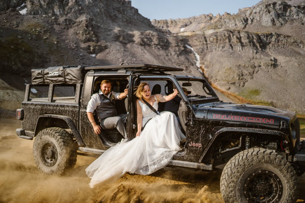 A couple peeling out in a Jeep in Colorado on their wedding day