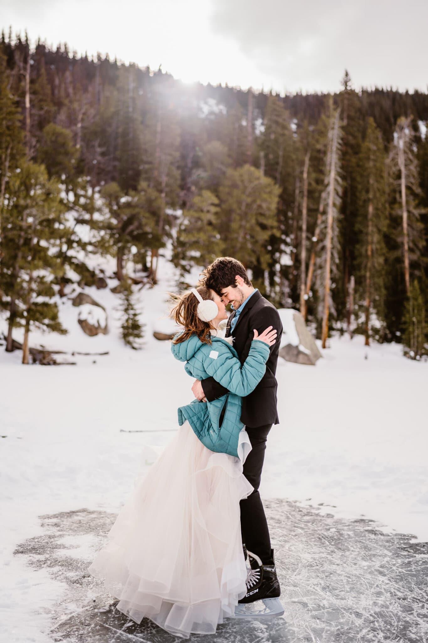 An elopement with the bride and groom ice skating in Colorado during the winter time.