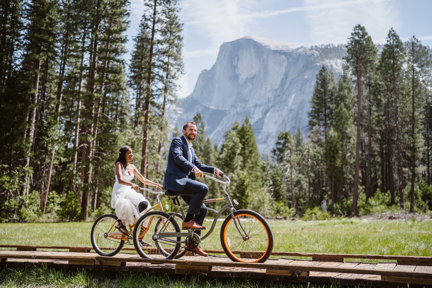 Couple riding bikes for their elopement activity.