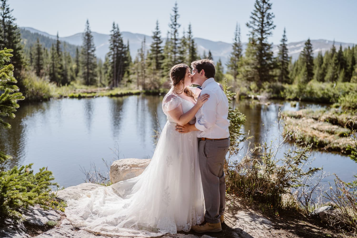 Bride and groom kissing at an alpine lake in Breckenridge