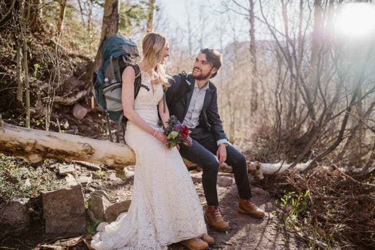 Couple taking a break during their hiking elopement in Colorado.