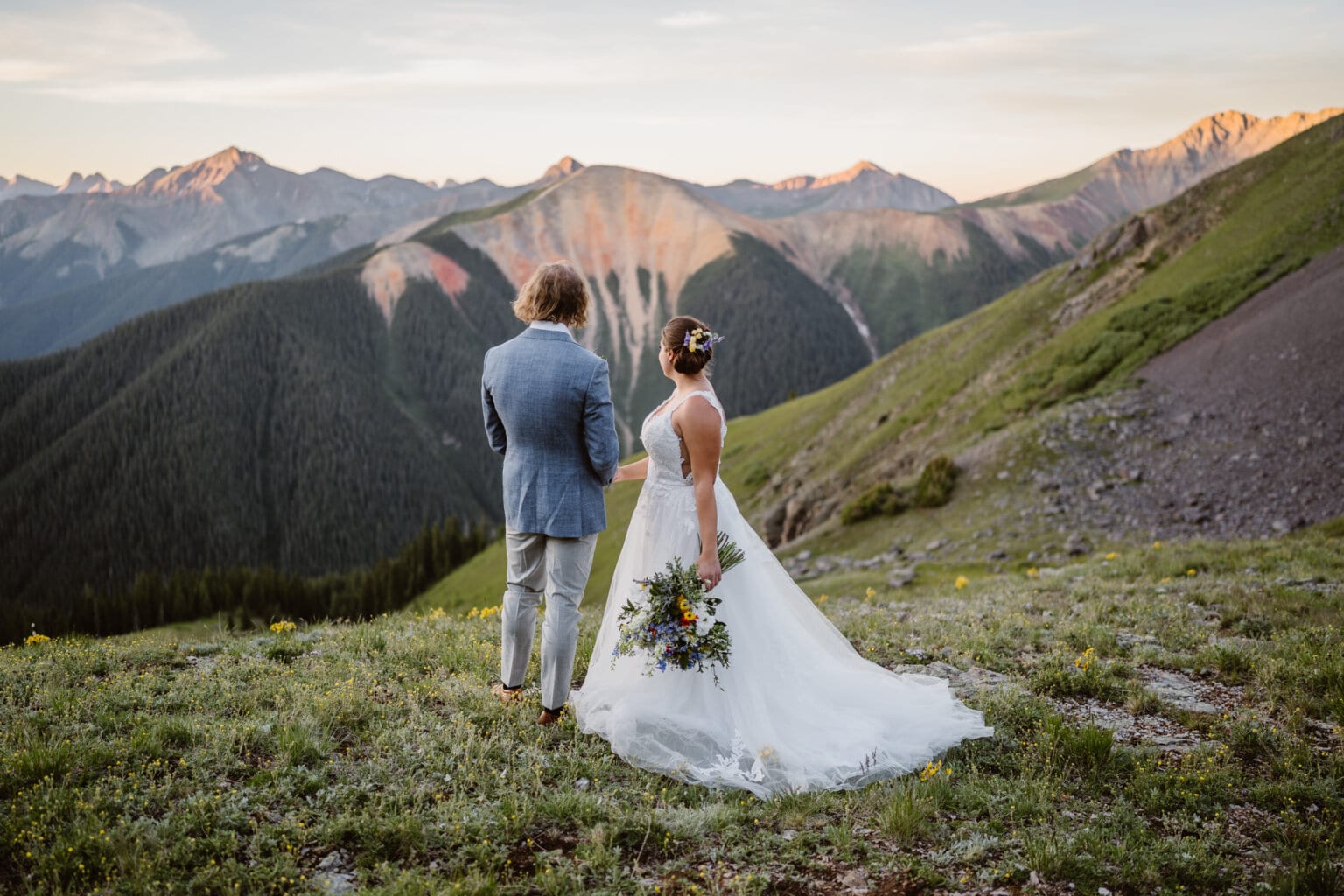 Couple looking off at sunrise in the San Juan Mountains of Colorado.